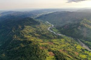 Madagascar, MaMaBay landscape | Drone photo over the Antainamalana river that flows. The river is one of the examples of ecosystem services with the source being from Makira Natural Park with many communities relying on its water for fishing and irrigation for rice farming | Paul Salaman | 5. WCS Drone DJI_002 view over Antainamalana river